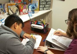 Child writing in speech and language therapy