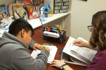 Child writing in speech and language therapy
